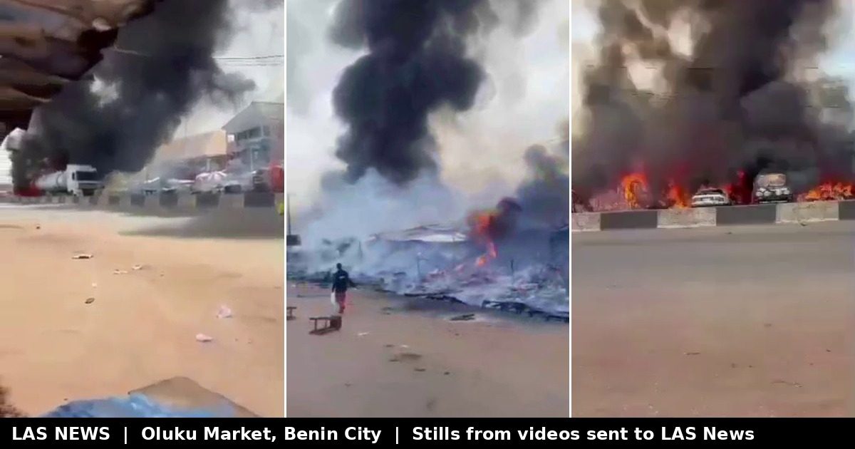 Smoke and flames rise over roadside shops and stalls at Oluku Market, Benin City